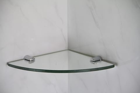 Étagère d’angle en verre trempé transparent avec supports chromés dans une salle de bain claire