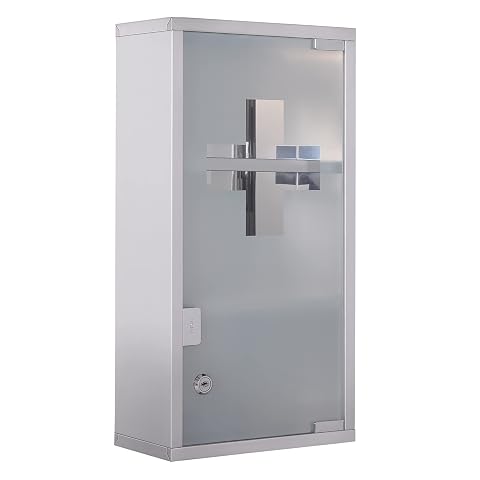 Armoire à pharmacie murale argentée avec porte dépolie et croix transparente, installée au-dessus d’une vasque claire.