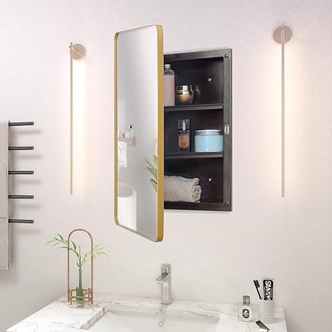 Armoire de salle de bain à miroir biseauté et cadre doré, installée au-dessus d’une vasque en pierre claire.